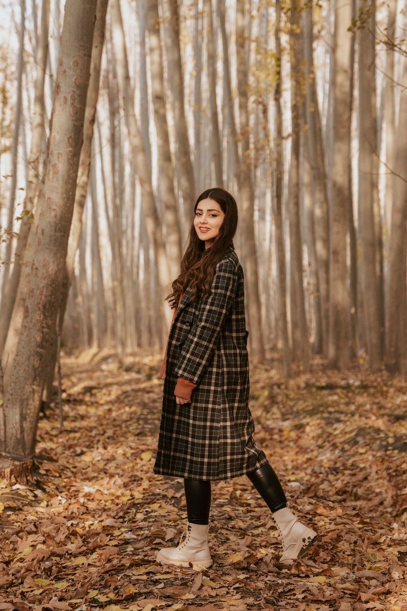 Woman in a plaid shacket and leggings outdoors in December