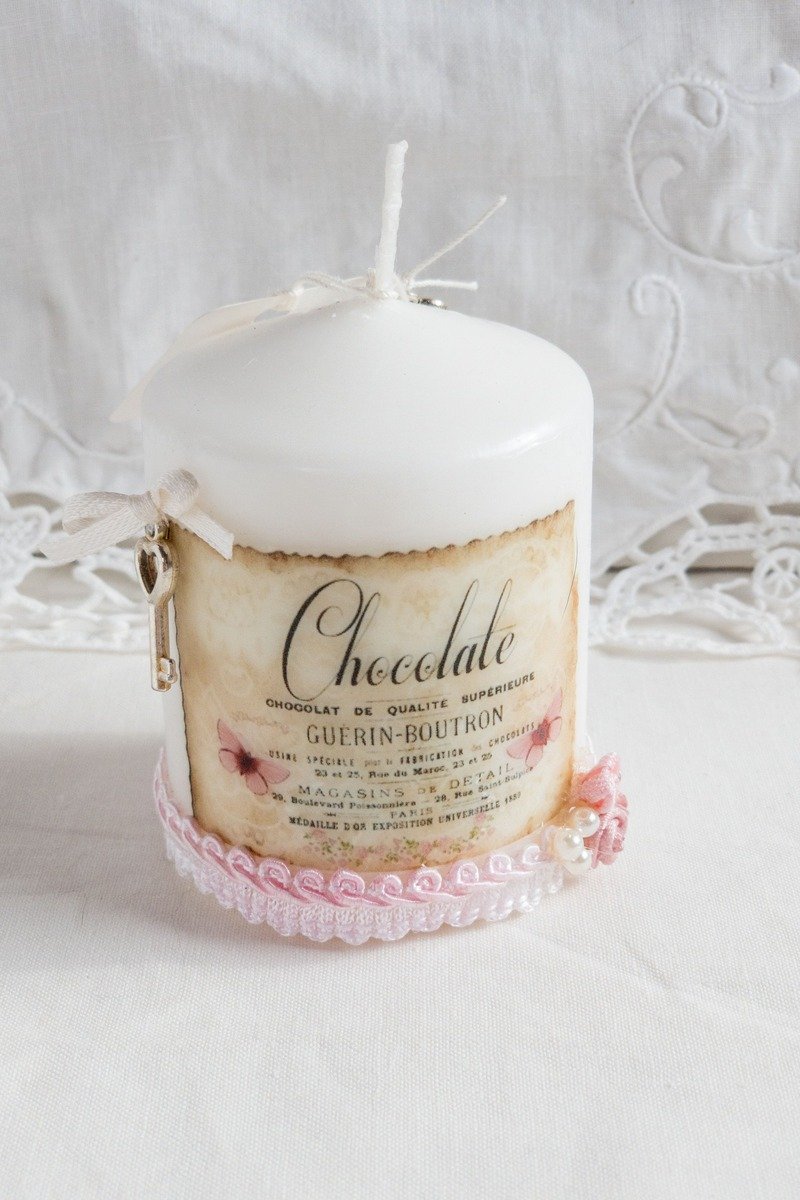 Scented candle in a decorative tin on a table