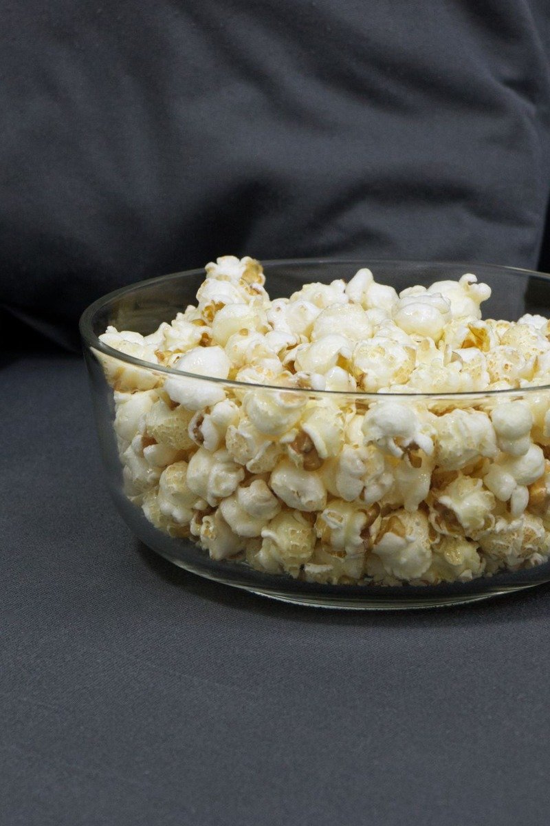Bowl of popcorn with TV remotes for a movie night gift