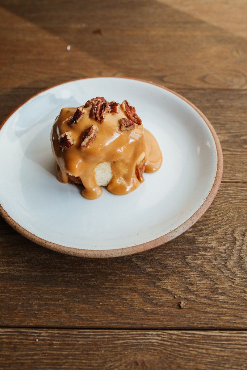 Individual sticky toffee pudding with caramel sauce and pecans