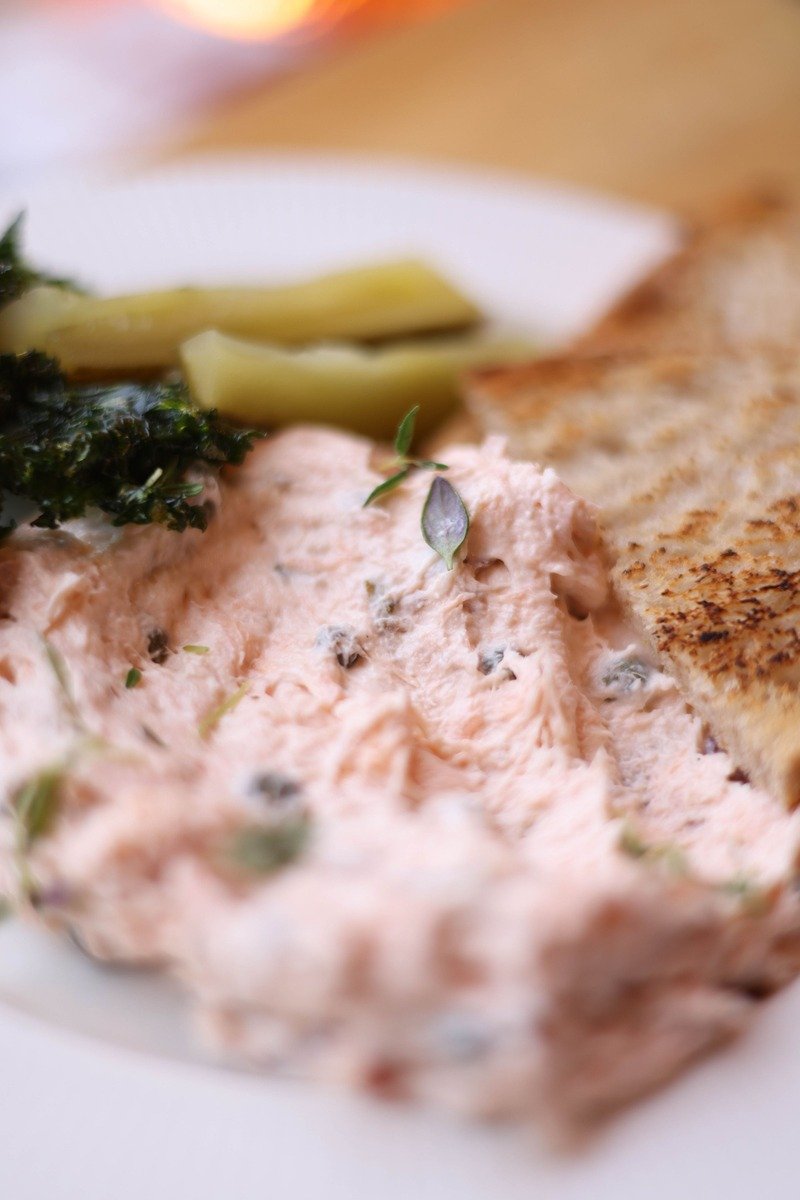 Smoked salmon spread on a plate with toast