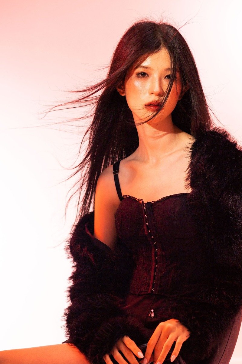 Woman in a black dress with a fur jacket