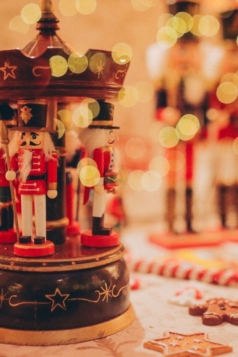 Traditional nutcracker figurines displayed in a festive Christmas setting with glowing bokeh lights