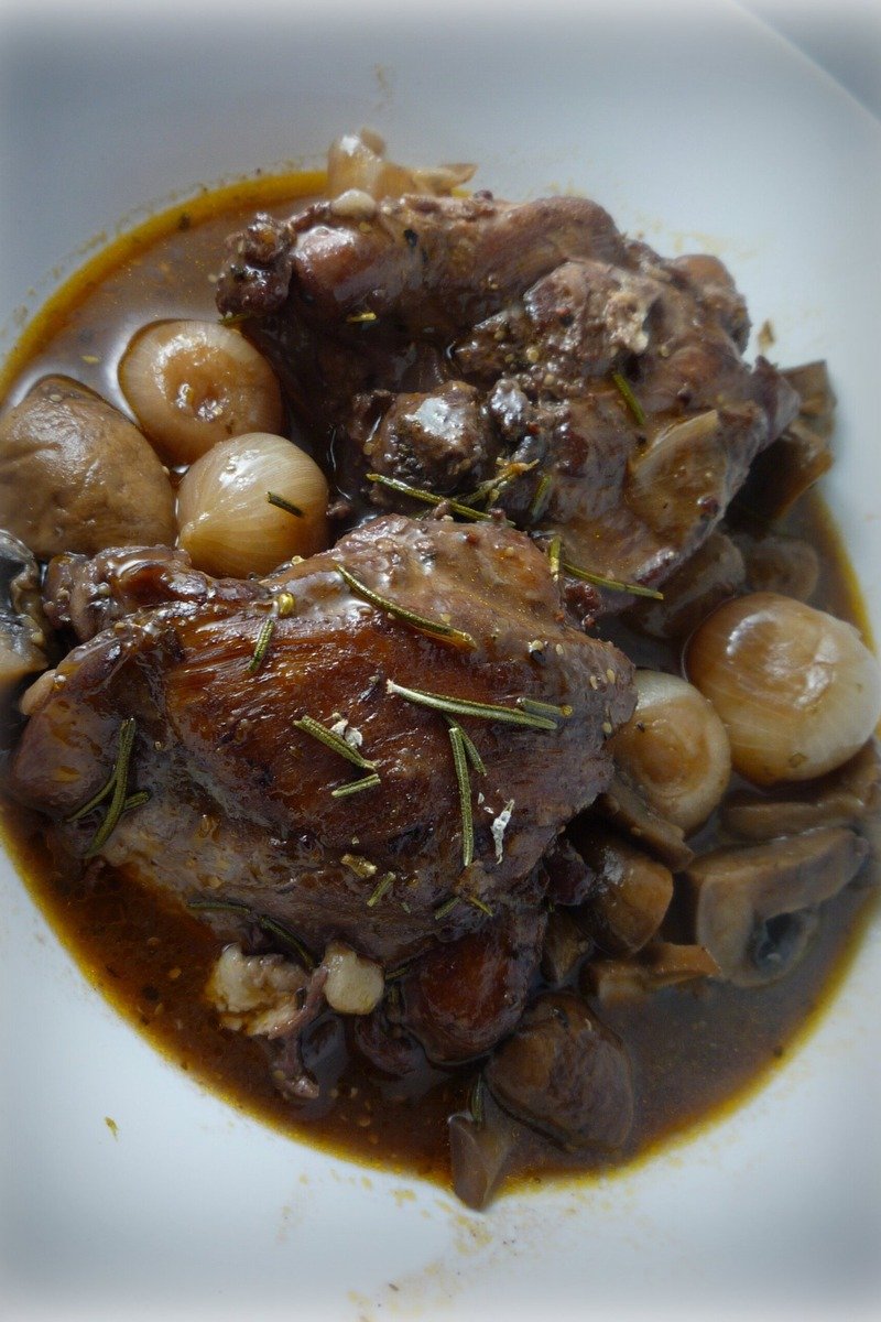 Braised chicken with mushrooms in a pan