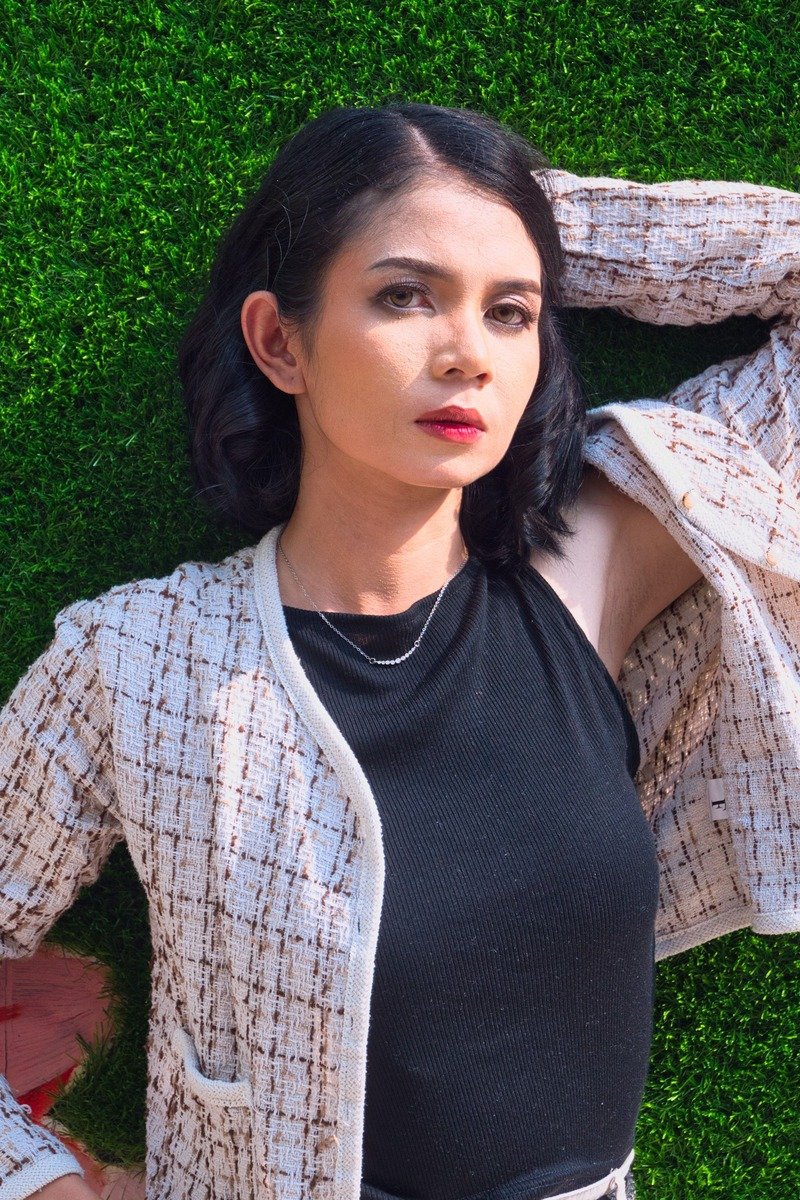 Woman in a tweed jacket and pencil skirt in a winter office outfit
