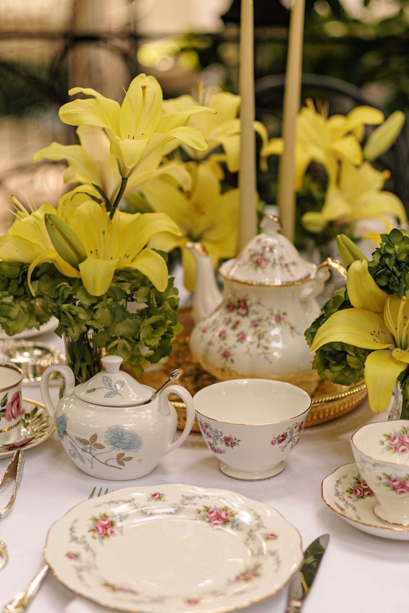 Vintage tea party table with tiered stands and flowers for a birthday