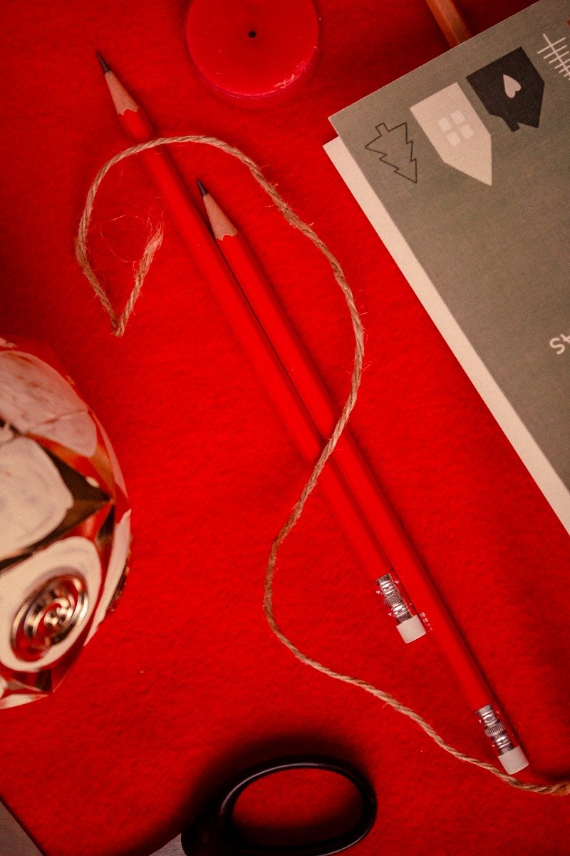 Christmas stationery flat lay with pencils and twine