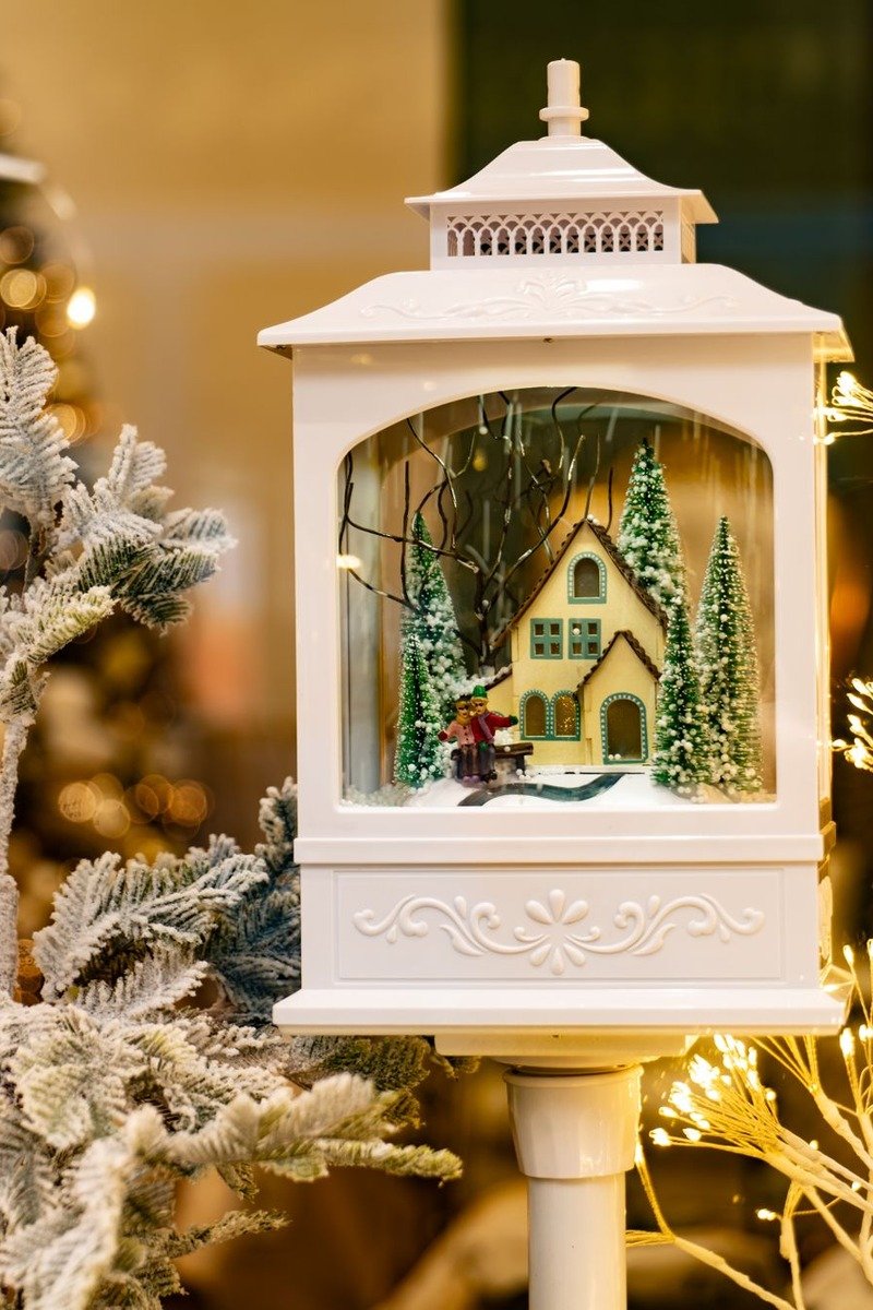 Miniature Christmas village inside a large lantern