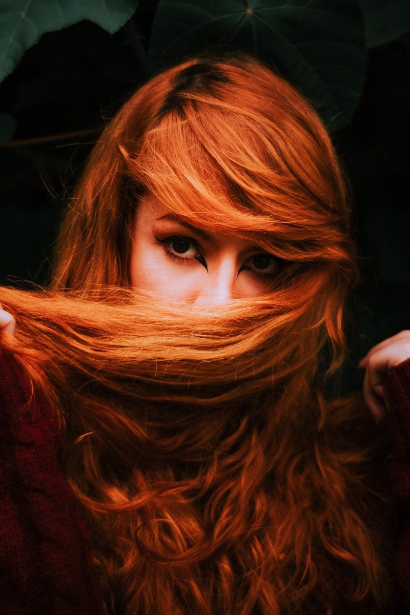 Auburn hair color on a woman in winter light