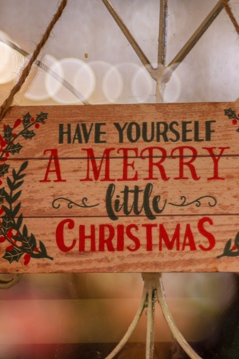 Wooden Christmas sign with painted holiday lettering