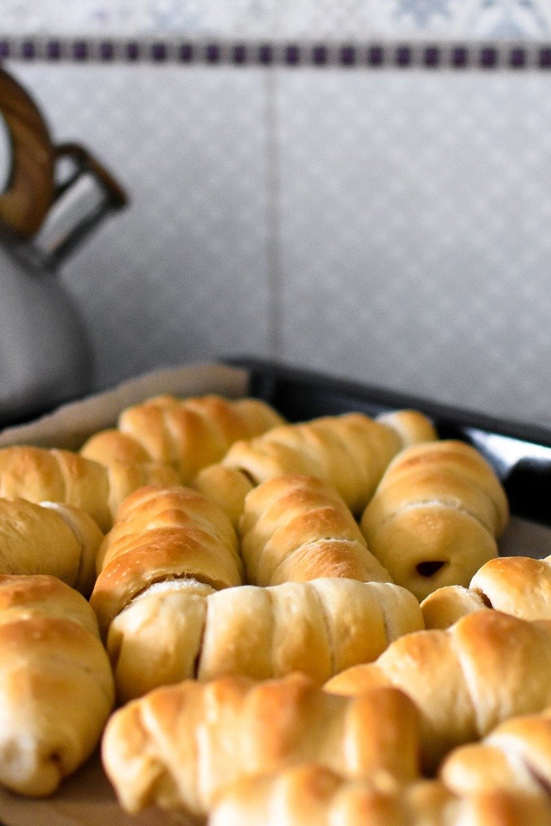Pigs in blankets on a parchment lined baking tray