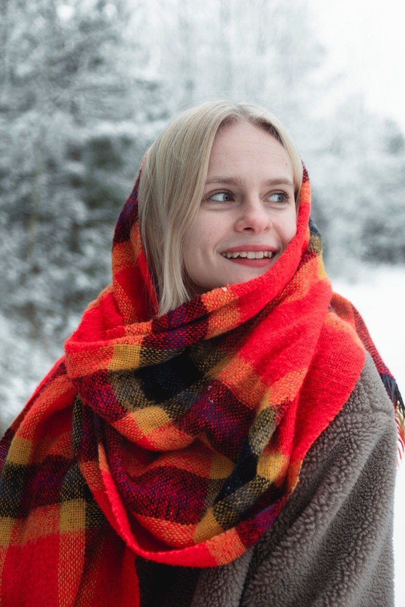 Woman wearing a plaid blanket scarf
