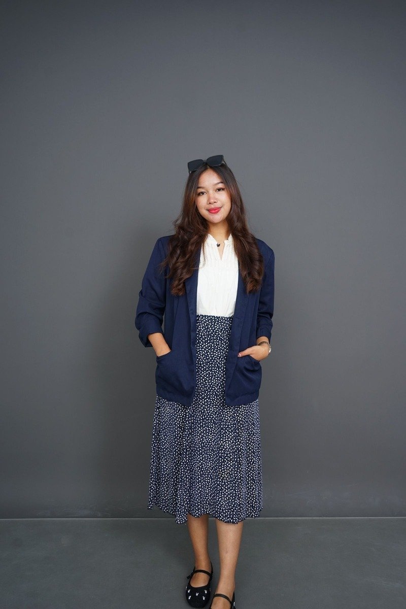 Woman in a blazer with a midi skirt