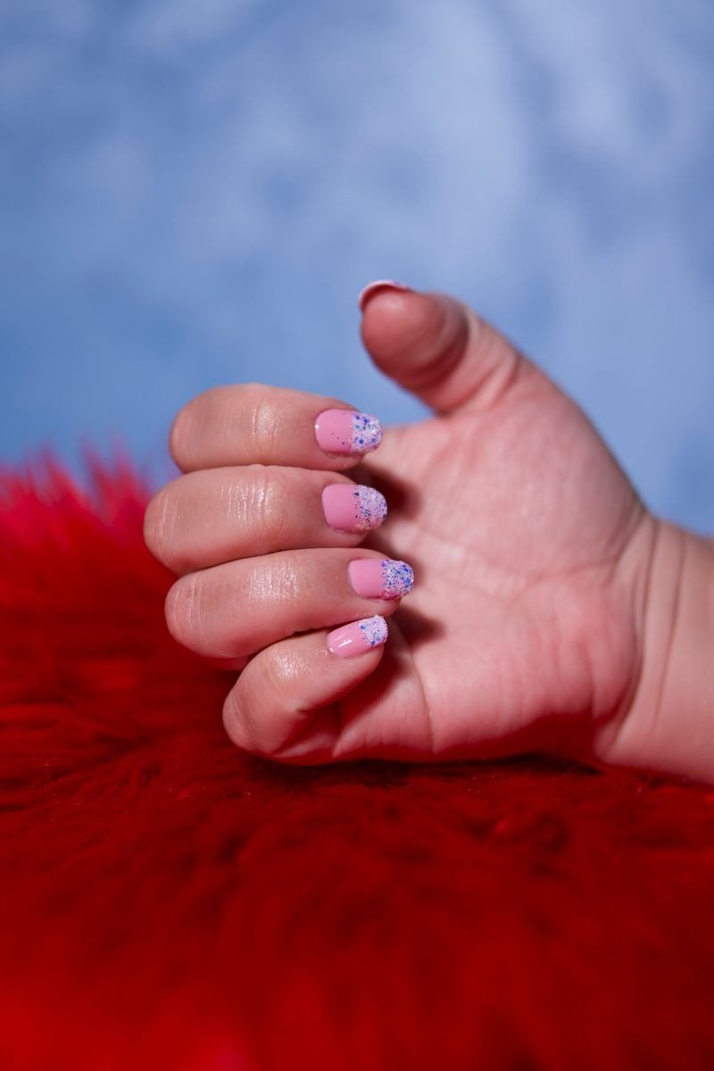 Dark nails with colorful firework bursts painted on each nail