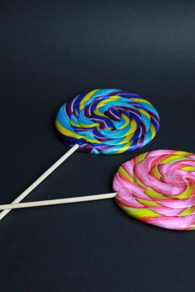 Bright candy-colored perfume bottle with lollipops
