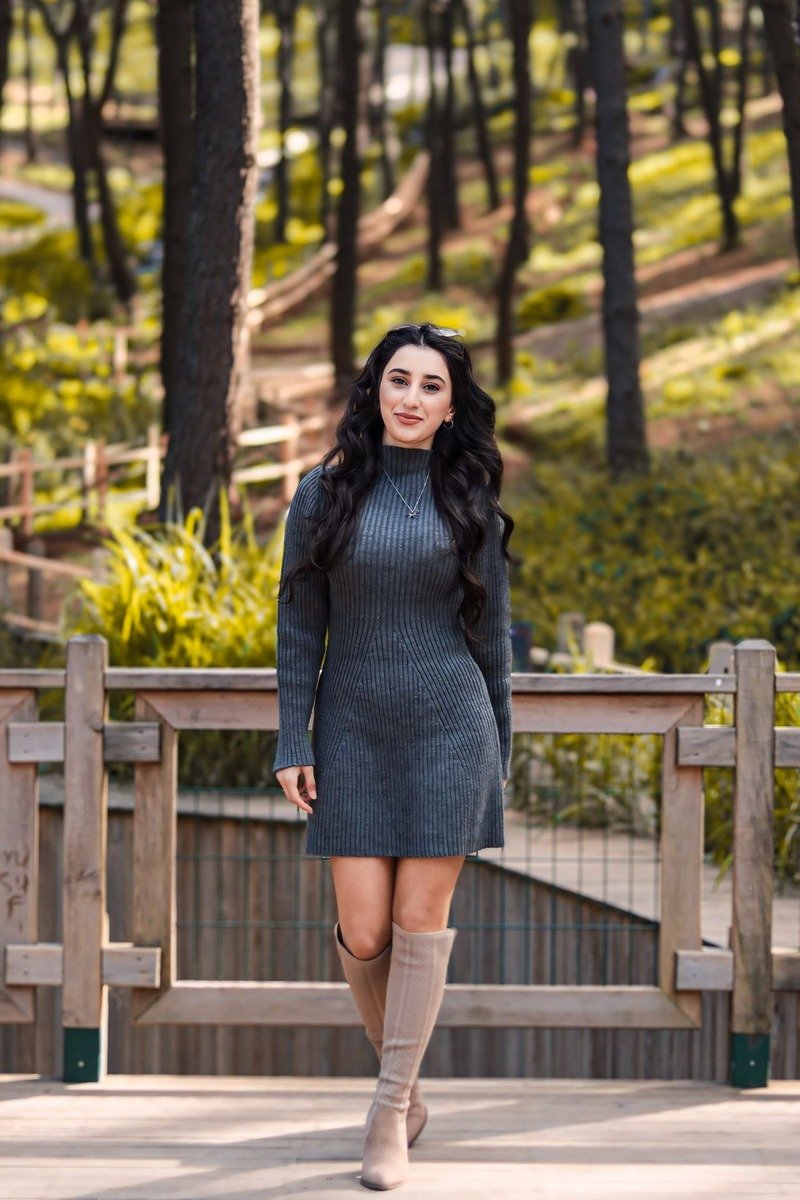 Mom wearing a sweater dress with knee-high boots