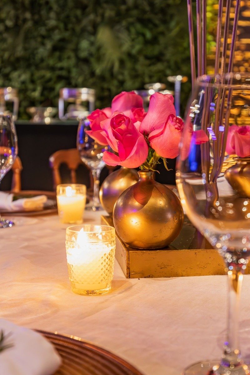 Rose gold birthday table setting with balloons and candles
