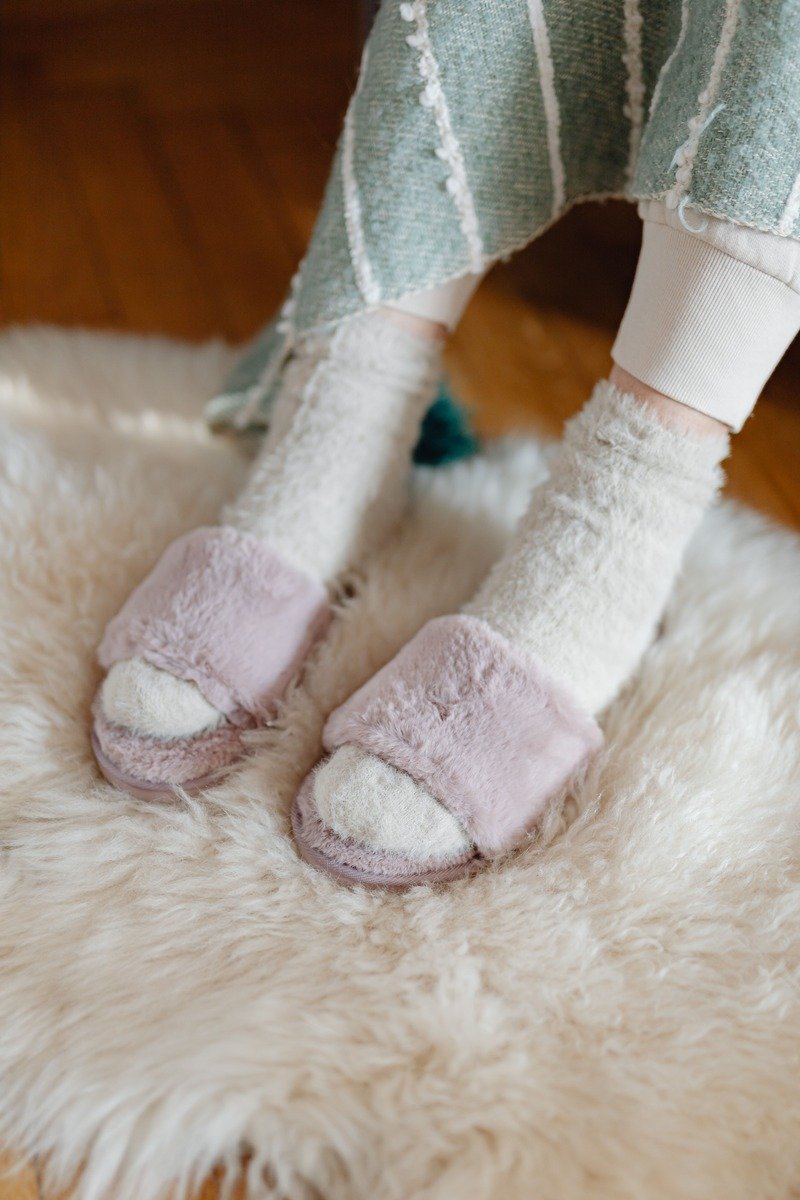 Fuzzy slipper socks by a fireplace