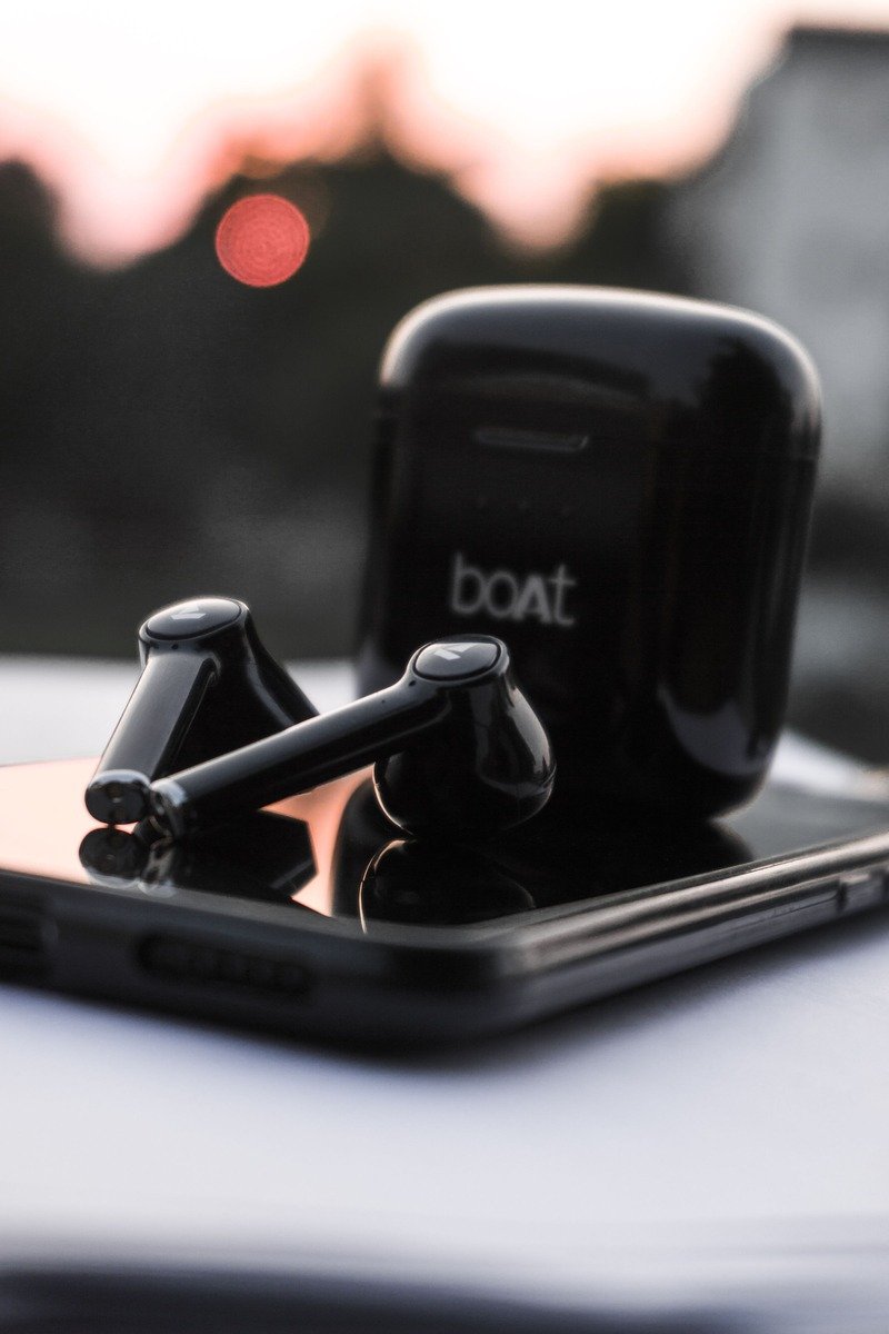 Wireless earbuds and charging case on a smartphone