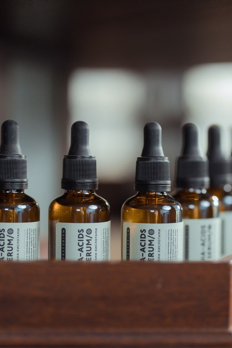 Serum bottles on a bathroom shelf