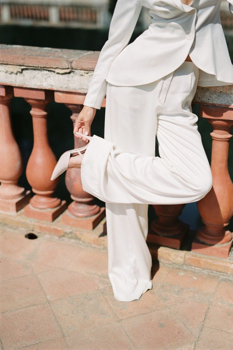 Woman in white wide leg trousers with a blazer