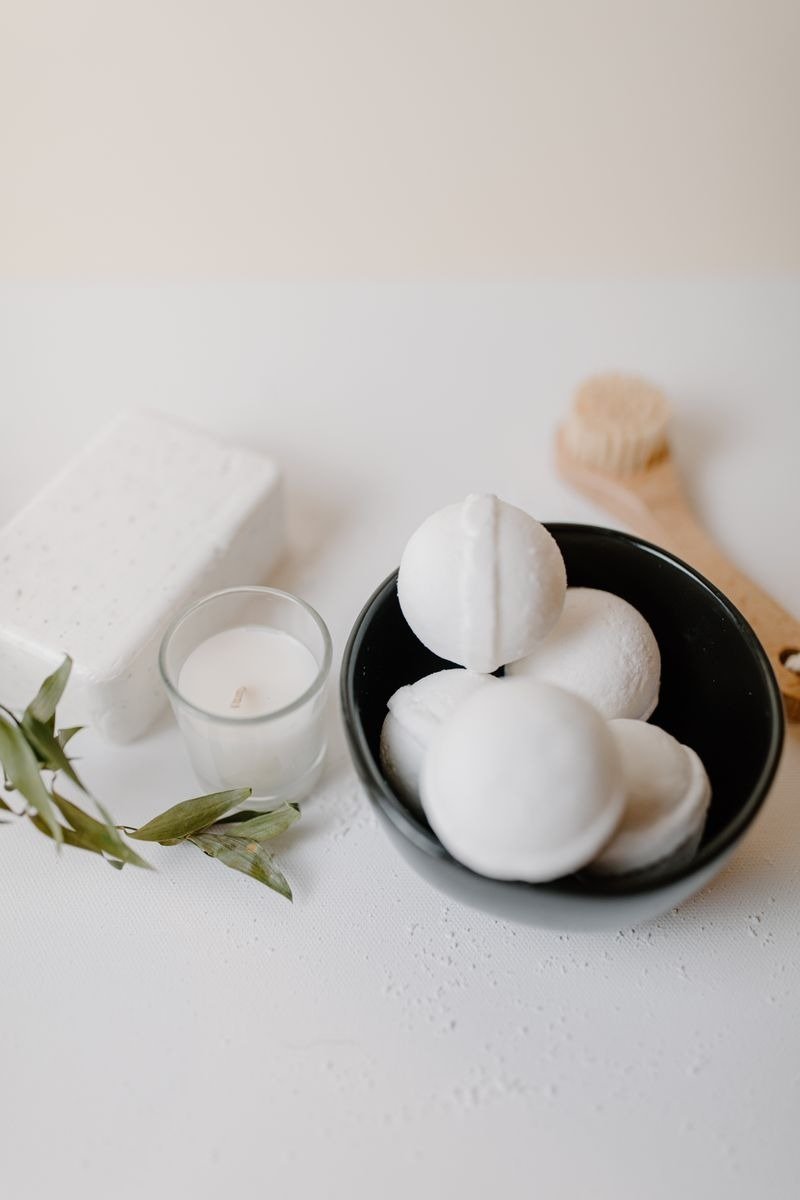 Coconut body wash bottle with a halved coconut beside it