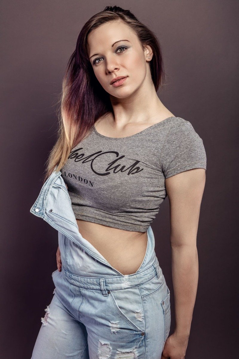 Mom wearing denim overalls with a graphic tee