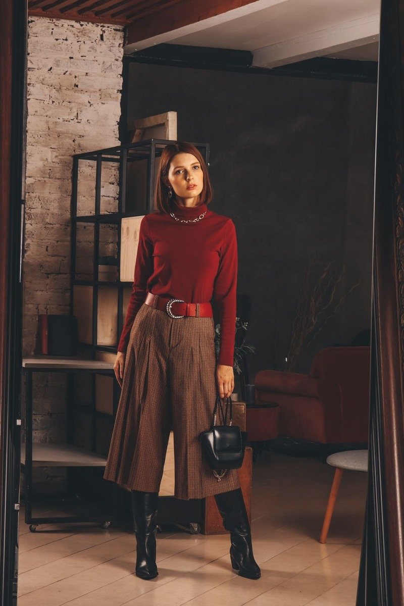 Woman in a red sweater and satin skirt for December festivities