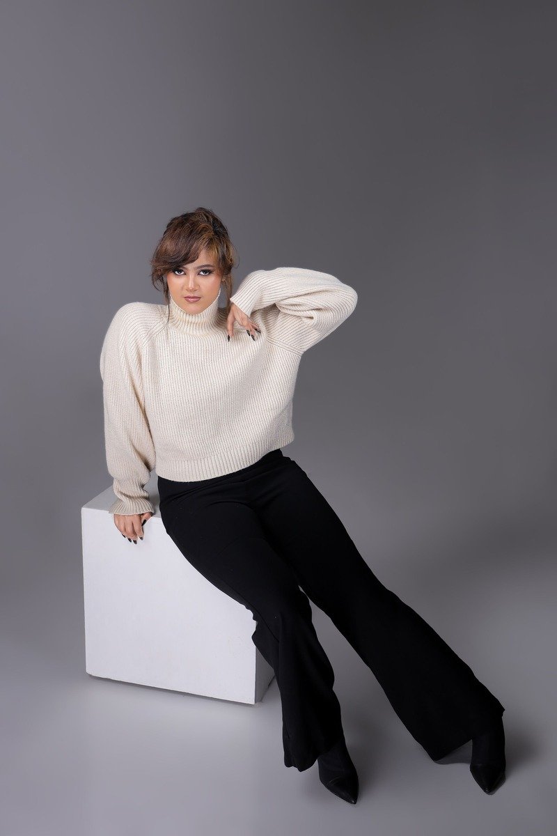 Woman in an oversized sweater with wide leg trousers