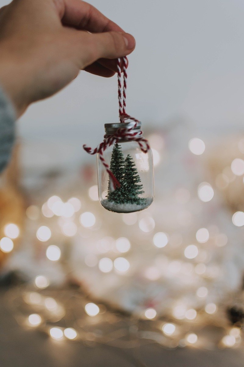 Miniature Christmas trees in a small glass jar ornament
