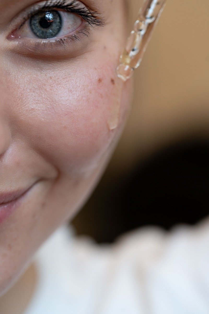 Applying hydrating serum to the face