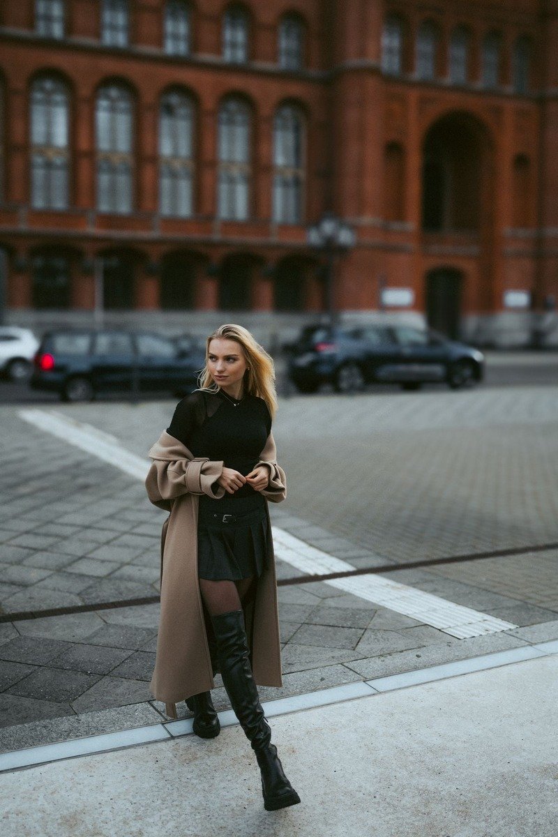 Black layers with a camel coat outfit