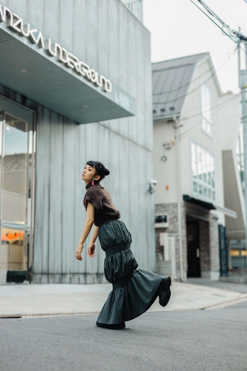 Mom wearing a knit midi skirt with a chunky cardigan