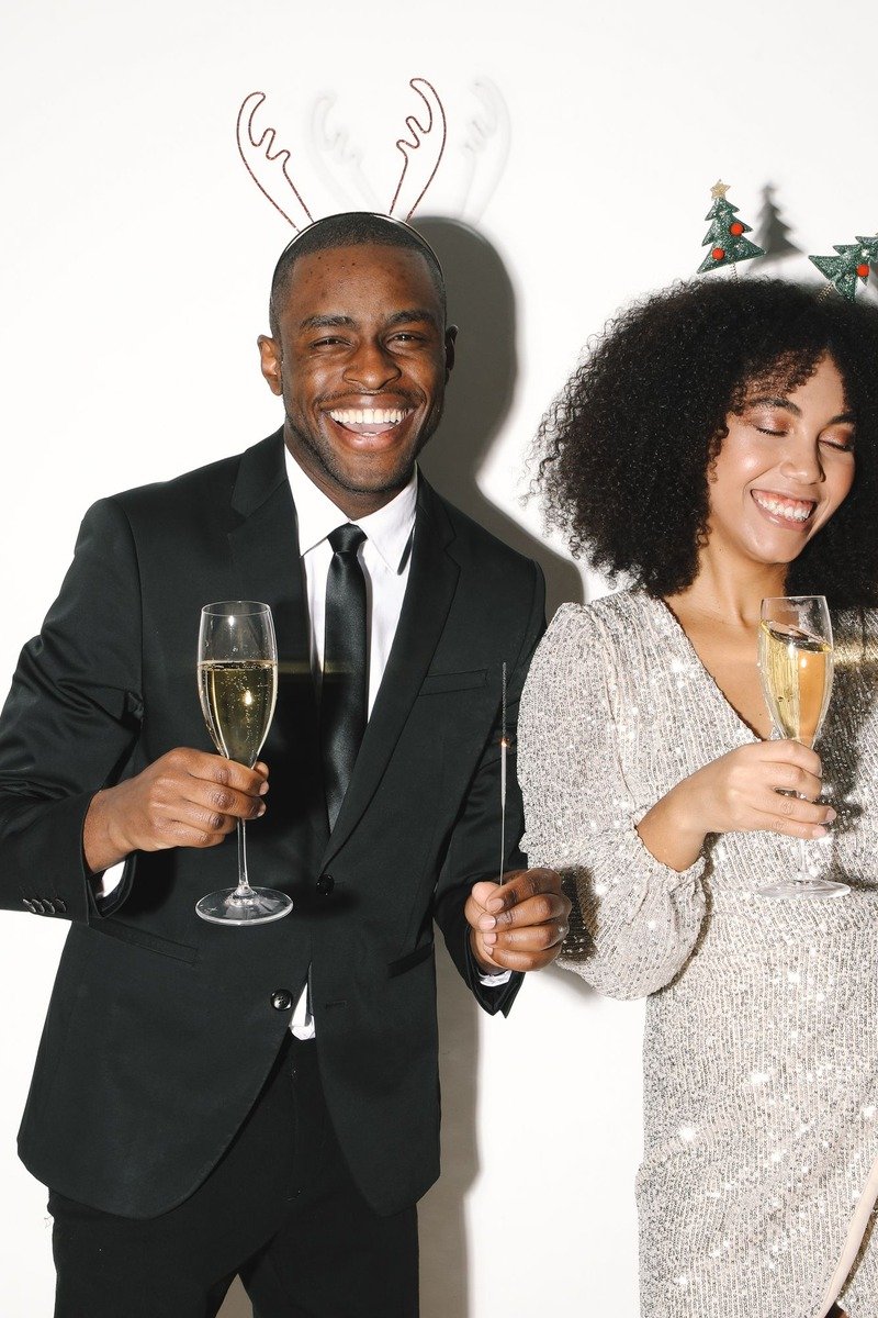 Couple in black tie holiday outfits at a Christmas photoshoot