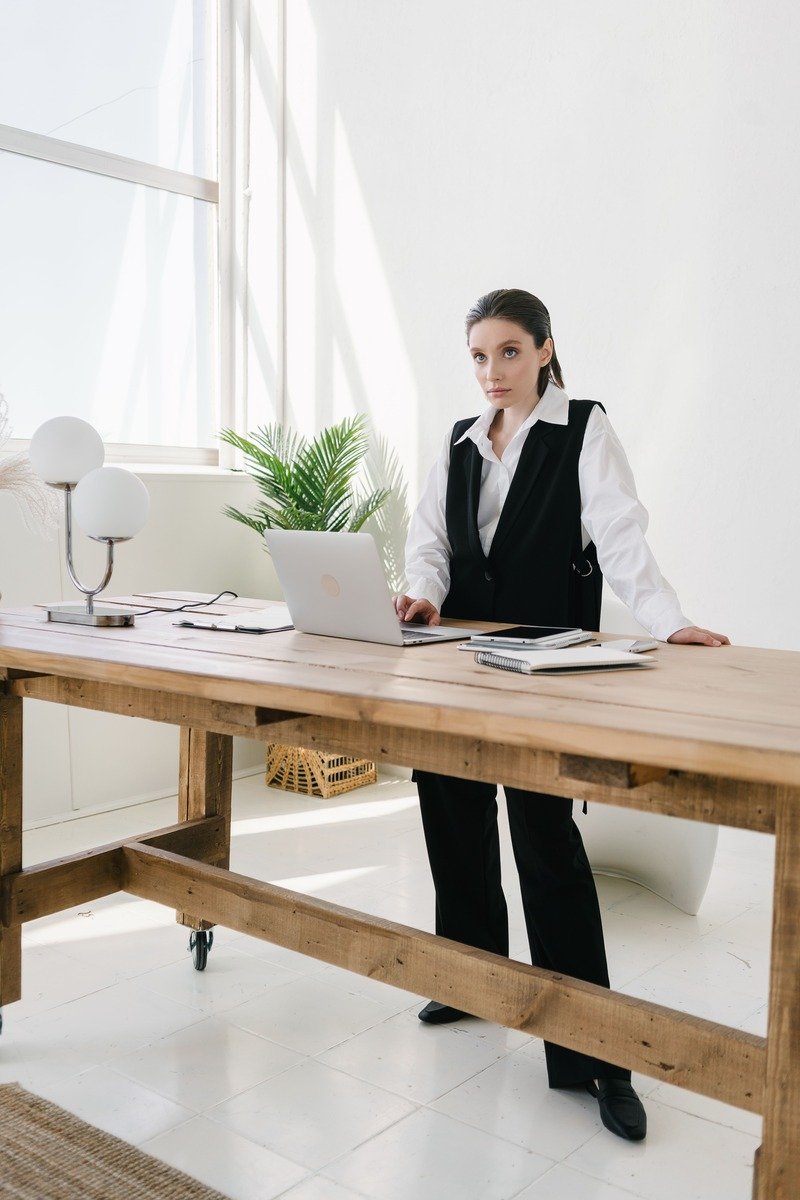 Woman in a sweater vest over a white shirt at the office