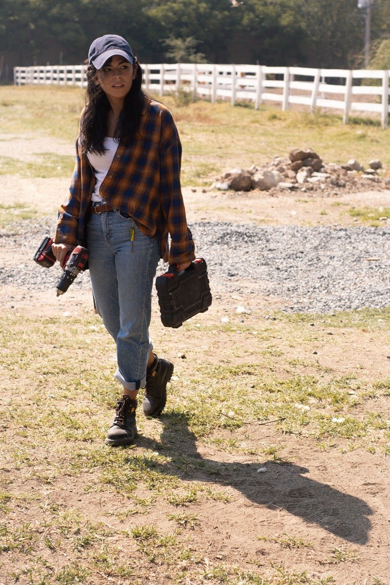Woman over 40 in a flannel shirt with jeans and winter boots