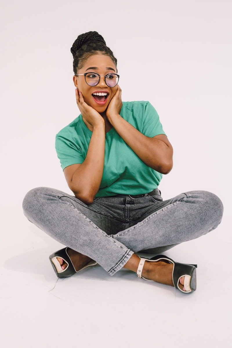 Woman in a green tee and grey jeans