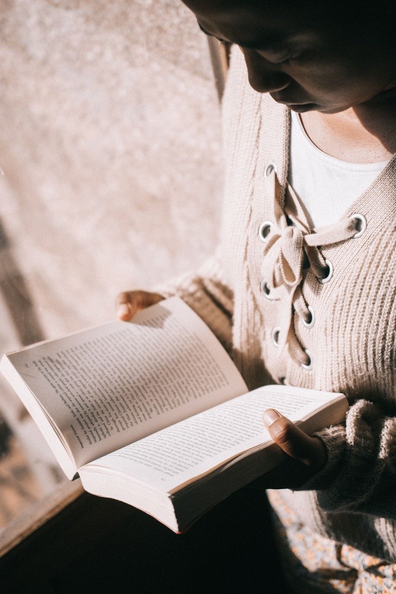 Woman reading a book in warm light