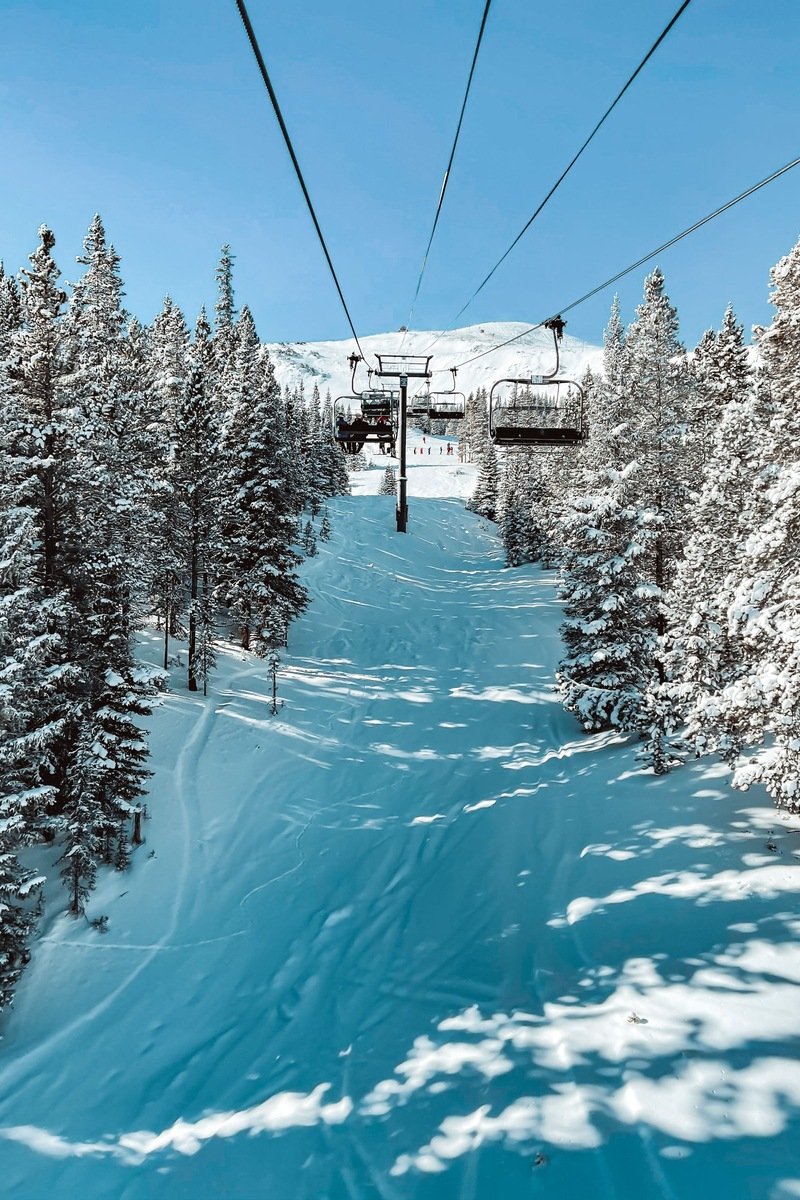 Deep powder slopes in Colorado with skiers in fresh snow
