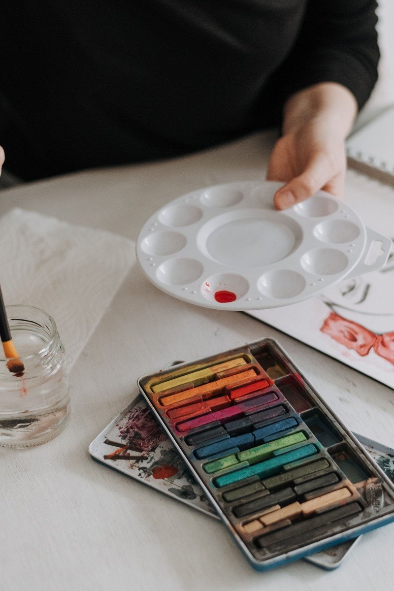 DIY bookmark crafting table with pressed flowers, ribbons, and art supplies