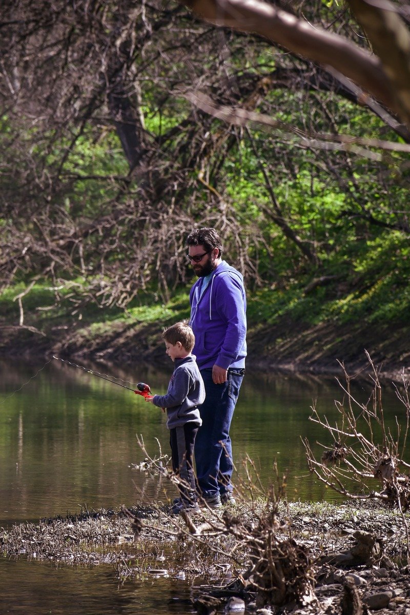 Father and young son fishing together