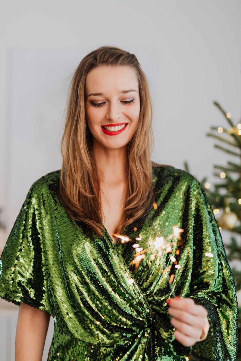 Woman in a green sequin dress at a party