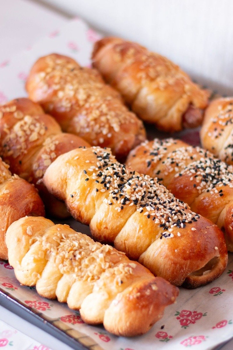 Golden sausage rolls on a paper lined tray