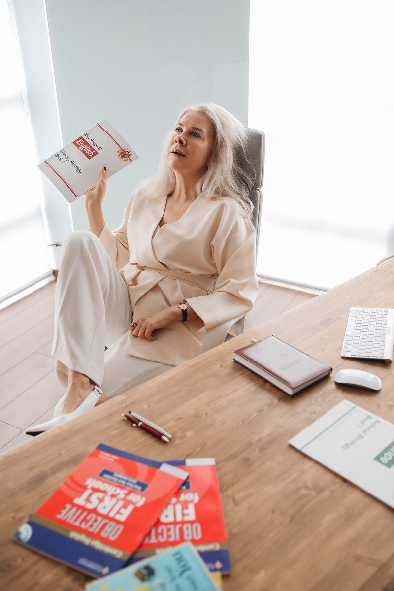 Woman in a cashmere sweater and tailored pants in a bright office