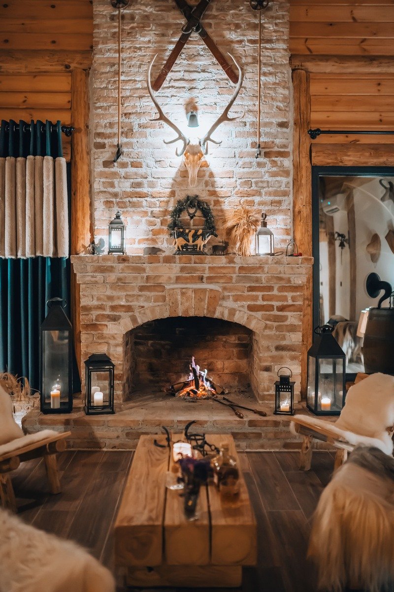 Lanterns with candles on a fireplace hearth