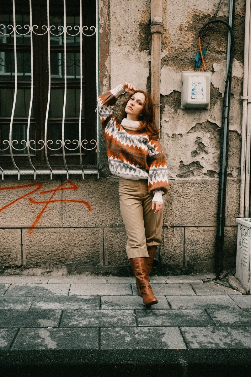 Woman in a Fair Isle sweater with dark slacks at the office