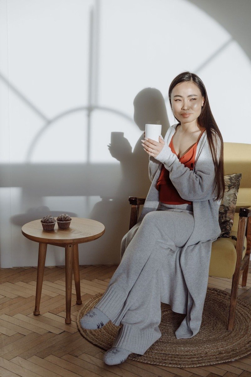 Woman in a matching knit lounge set relaxing at home in December