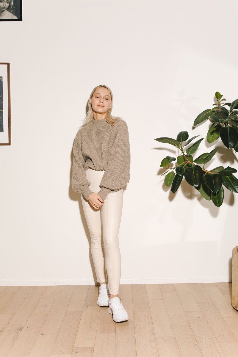 Woman over 40 in a head to toe cream knit outfit