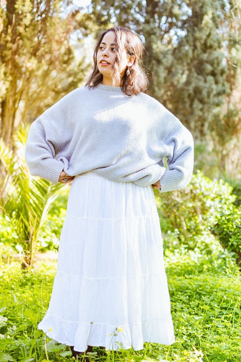 Woman in an oversized sweater with a flowing maxi skirt