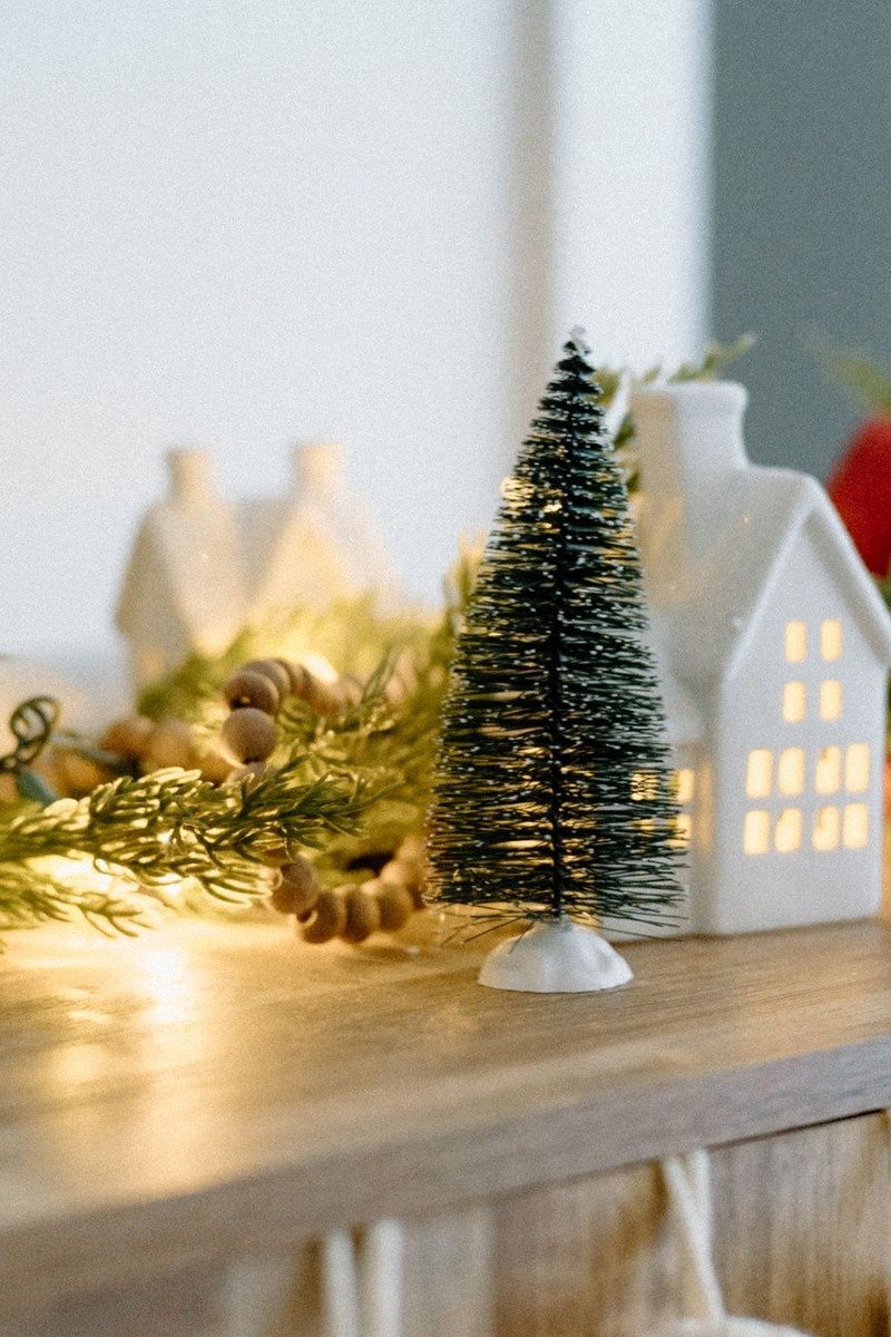 Christmas village display on a wooden sideboard